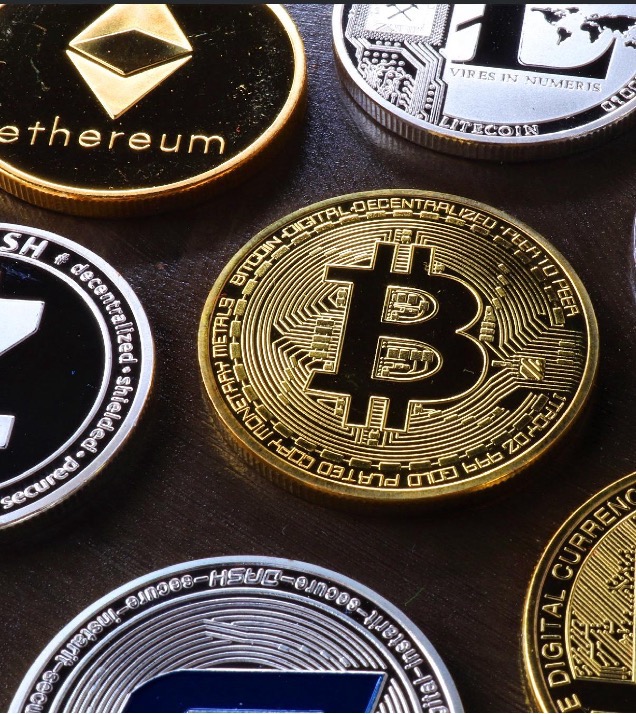 Digital currency coins arranged on a dark surface, representing on-chain digital assets.